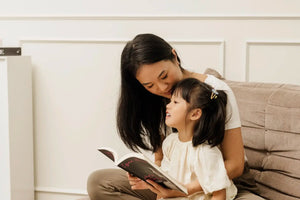 Mother and daughter engaging in storytelling and deep connection while reading together at home