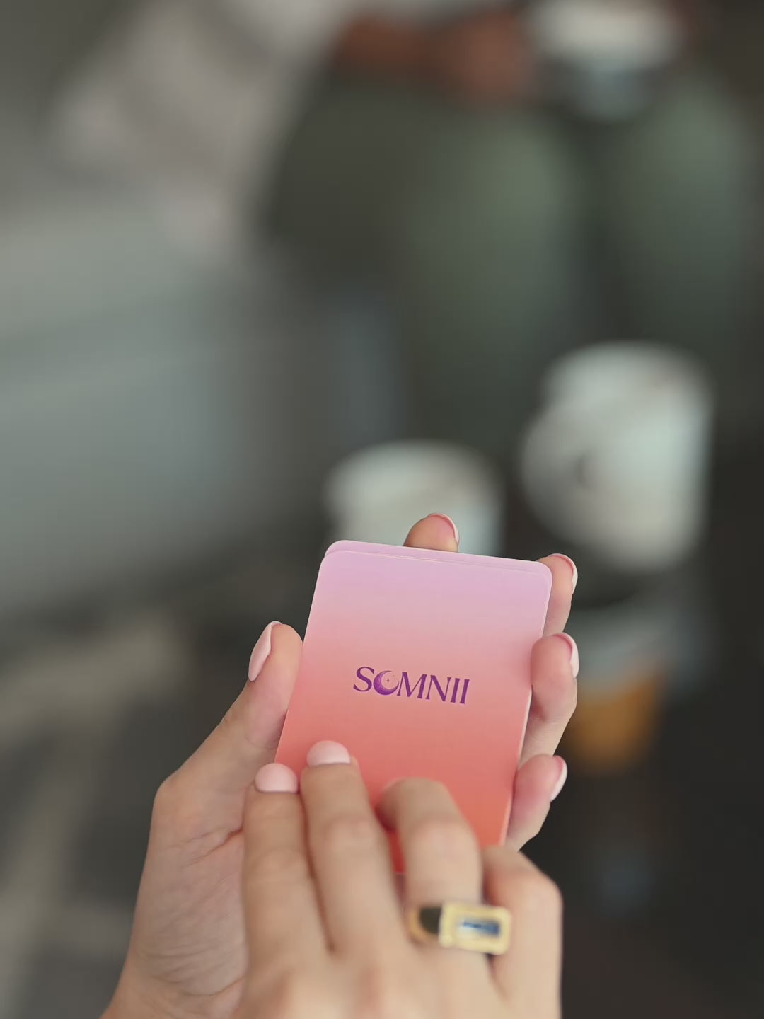 A mom turning a Somnii Says conversation card saying 'you can love your child and dislike parenting. 