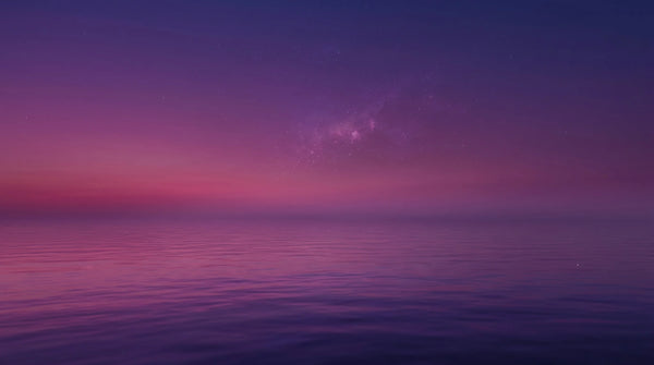 A serene sunset over a calm ocean transitioning into a starry night sky in Somnii’s signature purple and pink palette, symbolizing restorative sleep.