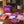 Somnii maternal wellness products on a wooden table, featuring the Somnii Sessions 'cheaper than therapy' conversation card box and Somnii's Sleep & Energy supplement sachet for moms.